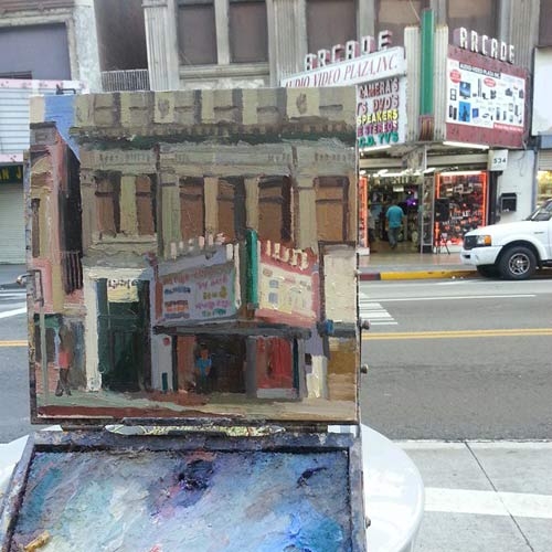 Alex Schaefer, one of the participants in the event, painting the Broadway Arcade in L.A.
