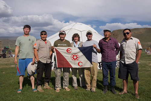 Fox, center, with researchers and nature reserve staff holding Explorers Club Flag 179
