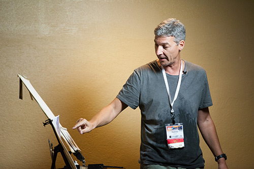 Vladislav Yeliseyev paints a demo for an audience at the Plein Air Convention & Expo.