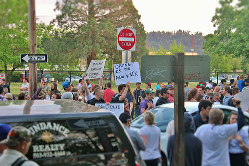 Counter-protesters with imaginative signs. Photo by Alison Elliott