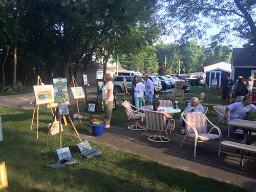 Paintings on display after a paint-out at the Wawasee Yacht Club