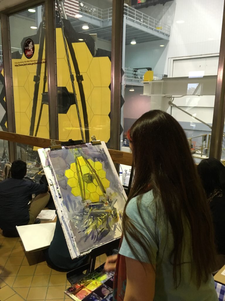 Joanna Barnum painting the James Webb Space Telescope at the NASA Goddard Space Flight Center in Greenbelt, MD. Photo by Maggie Masetti