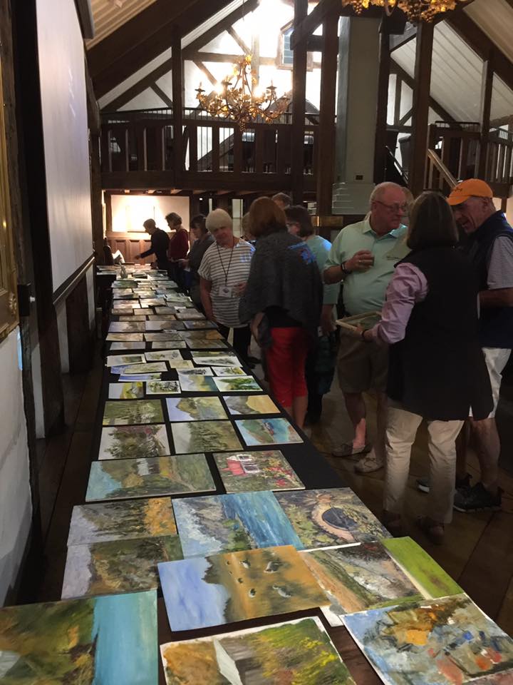 Artists browse paintings produced after one of their first days at work