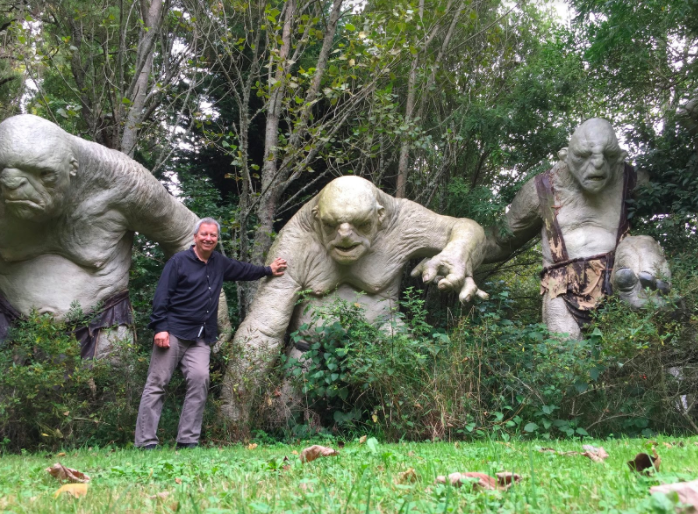 Eric Rhoads with some stone giants from the Hobbit movies at a private sculpture garden in New Zealand.