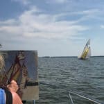 Debra Huse plein air painting on a boat