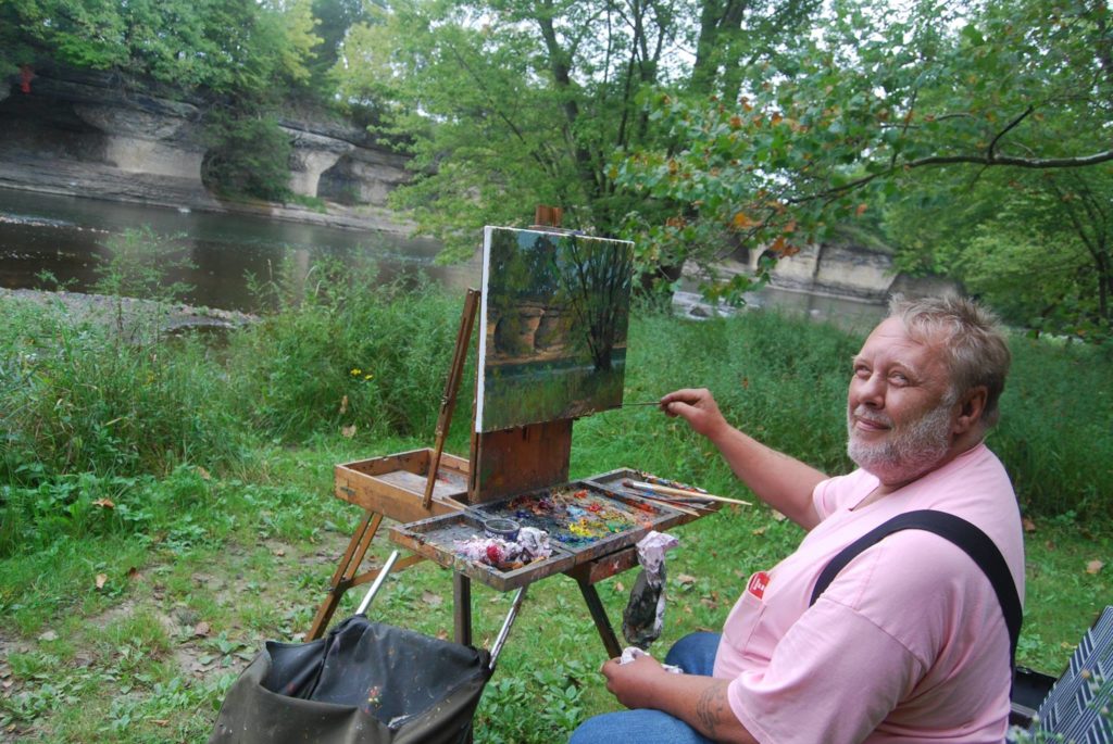 Painting rivers - Plein air painter at easel