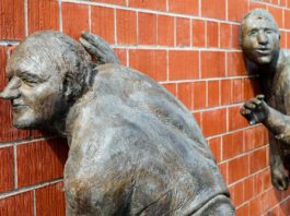 Sculpture of men listening