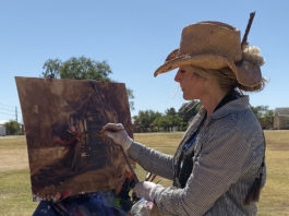 Artist Spotlight: Krystal W. Brown Woman painting outdoors in a hat