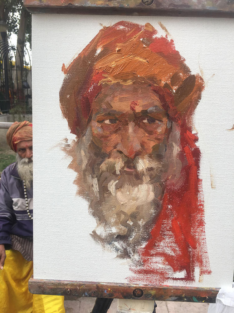 Portrait of homeless man in India as he sits for his painting.