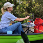 Artist painting outdoors in a canoe