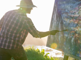 Artist Ryan Jensen paining outdoors