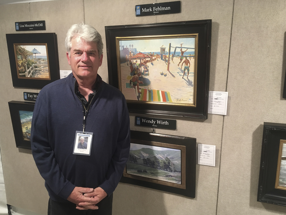 Artist Mark Fehlman in front of his paintings at the Laguna Beach Plein Air Painting Invitational