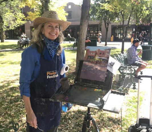 Artist Michele Byrne painting outdoors in Santa Fe