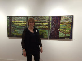 Artist Spotlight: Sandi Pillsbury Woman artist standing in front of her painting.