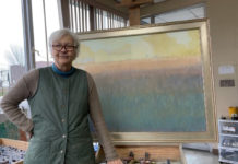 Artist Spotlight: Carol Strock Wasson Woman artist in front of a painting on an easel