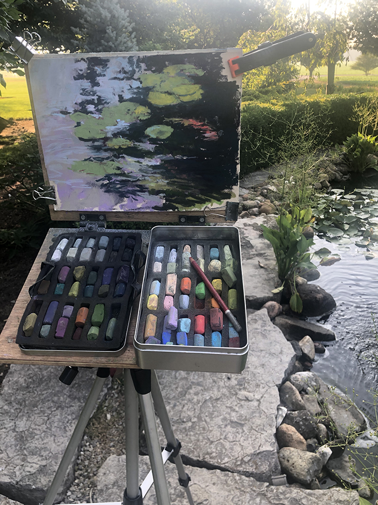 Pastel painting of a koi pond on the easel at the location