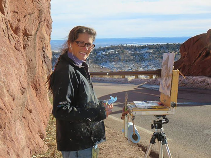 Woman painting outdoors in Red Rocks Park