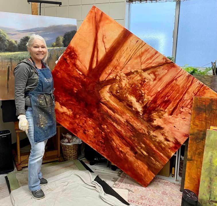 Brenda with the base coat of her landscape painting