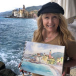 picture of artist Cindy Briggs holding her painting