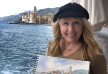 Artist Spotlight: Cindy Briggs picture of artist Cindy Briggs holding her painting