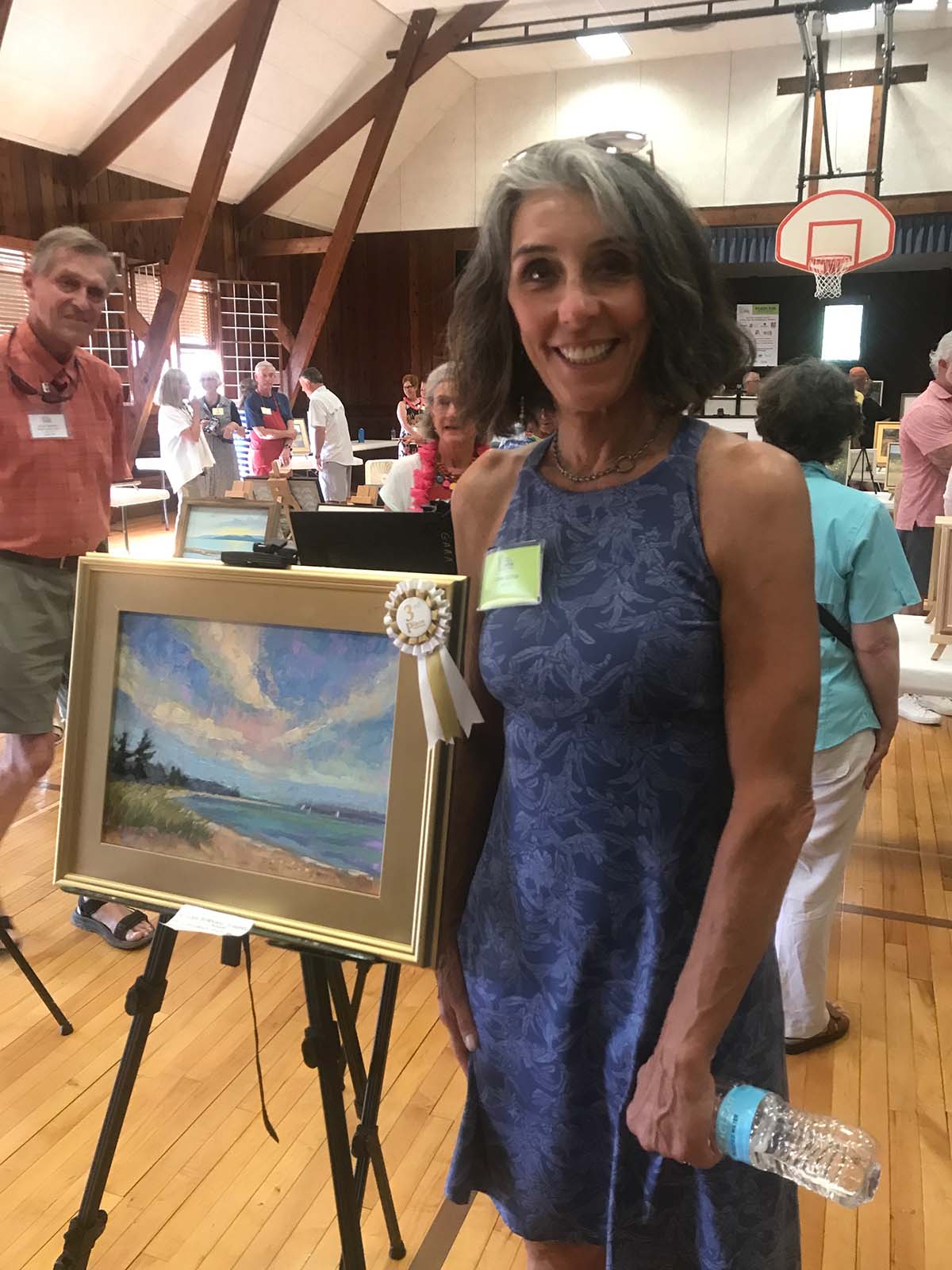 artist posing with her 3rd prize painting