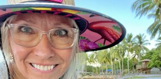 Artist Pamela J. Ayres pausing her painting to pose with PleinAir Magazine