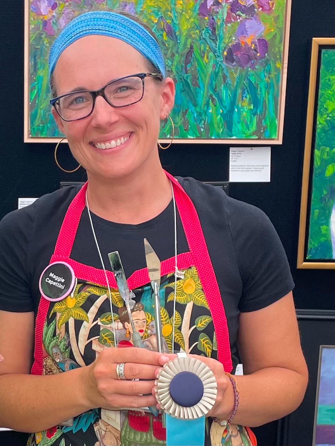 The artist and her knives, awarded Outstanding Achievement in Painting at Wheaton Art Walk, 2022. Photo credit Amdur Productions