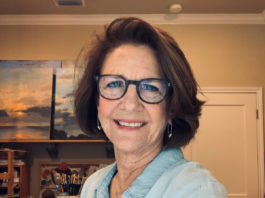 Artist Spotlight: LAUREL DANIEL artist taking a photo of herself in her studio