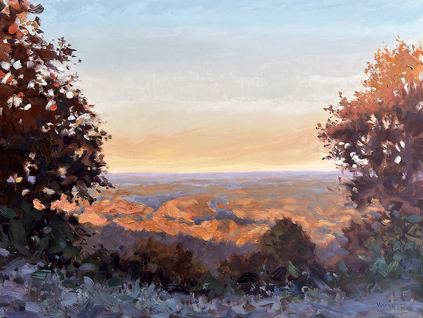 oil painting of sunset; perspective overlooking mountains with foliage in the foreground. Trees have deep set tones, framing the picture