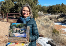 Artist posing with her painting en plein air