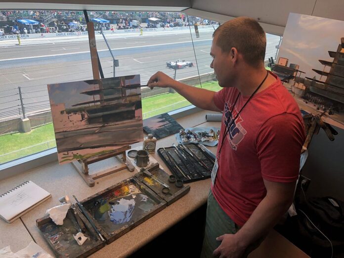 photo of artist actively painting at raceway