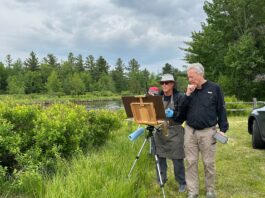 Painting events - Eric pauses to chat with an artist who found the perfect scene.