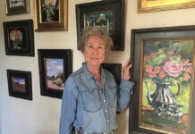 Artist Spotlight: Cynthia Inson Artist posing with her paintings