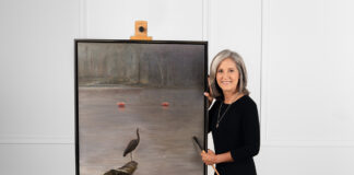 Sherry posing with her painting