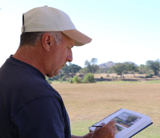Paul Kratter sketches the unique shapes of the trees at the Mala Mala Game Reserve.