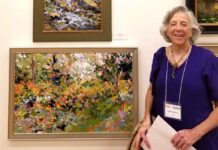 artist with her paintings