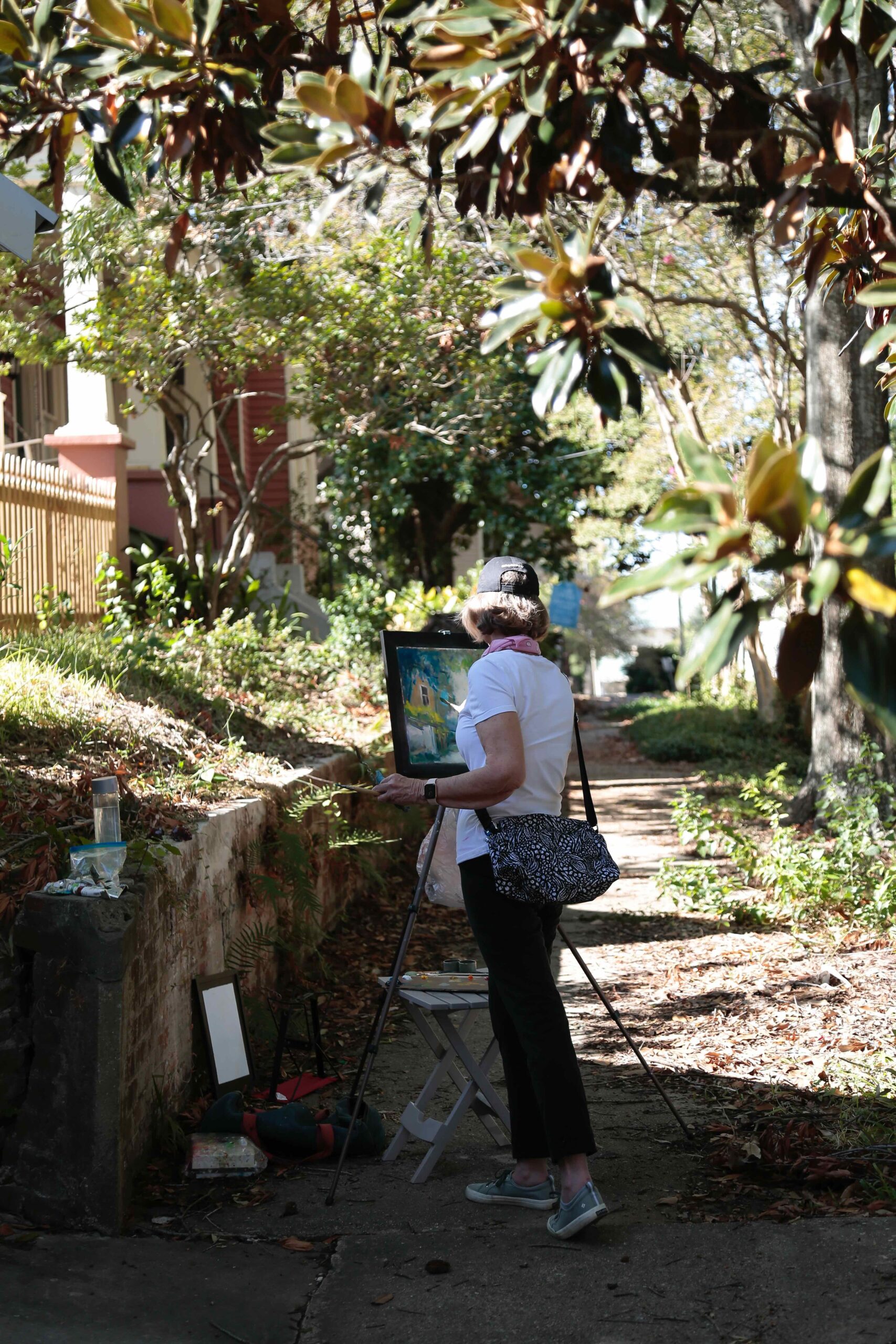 Sarah Burnette painting beneath old magnolia trees in the center of historic Baton Rouge