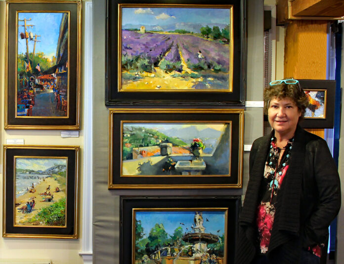 photo of artist with her plein air paintings