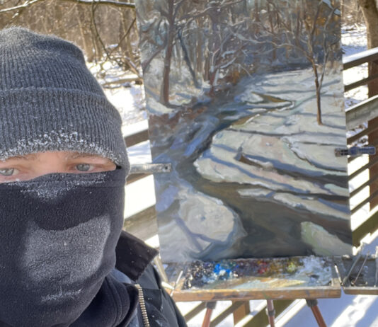 photo of artist taking selfie with painting