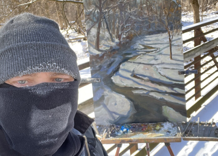 photo of artist taking selfie with painting