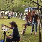 Learning How to Paint en Plein Air, Together Other painters lined up along the edge of the open spaces of the park.
