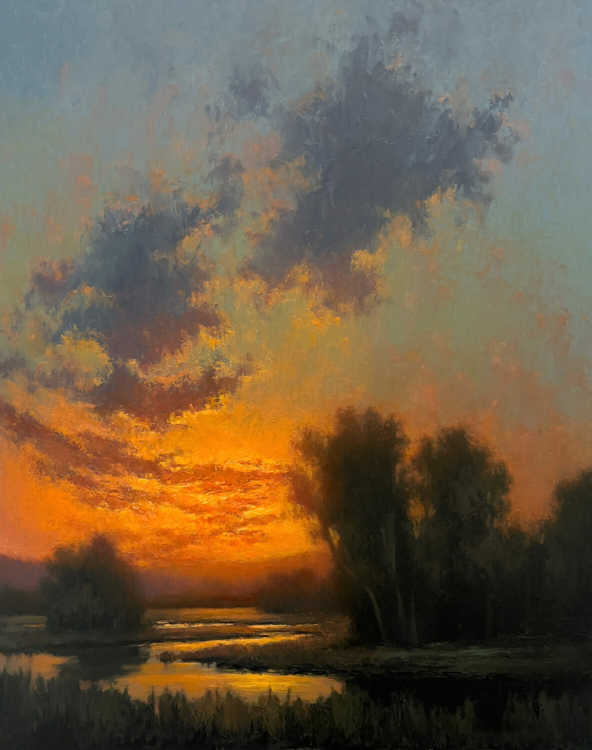 A vibrant sunset over a marshland, with orange and yellow hues lighting up the sky, dark silhouetted trees, and reflective water in the foreground. 15th Annual PleinAir Salon Art Competition