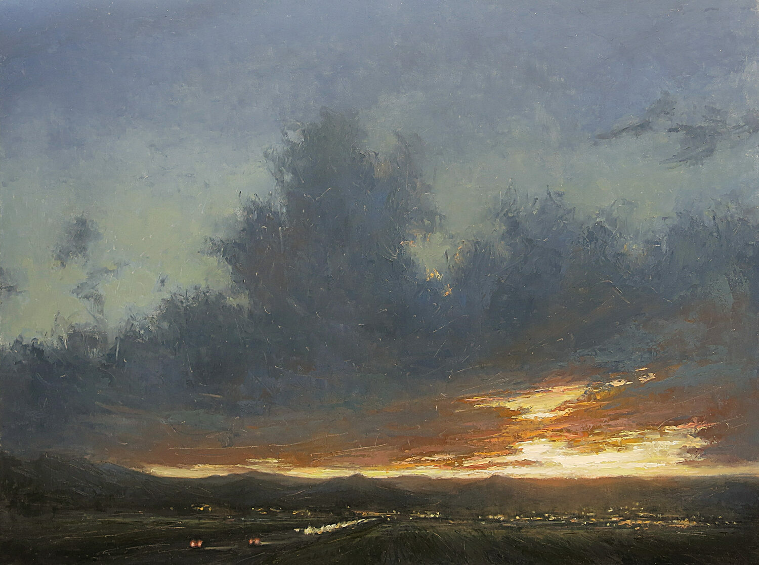 A dramatic sunset over distant mountains, with dark, textured clouds spreading across the sky and a warm orange glow on the horizon. Small lights from a town or cars are visible below. 15th Annual PleinAir Salon Art Competition