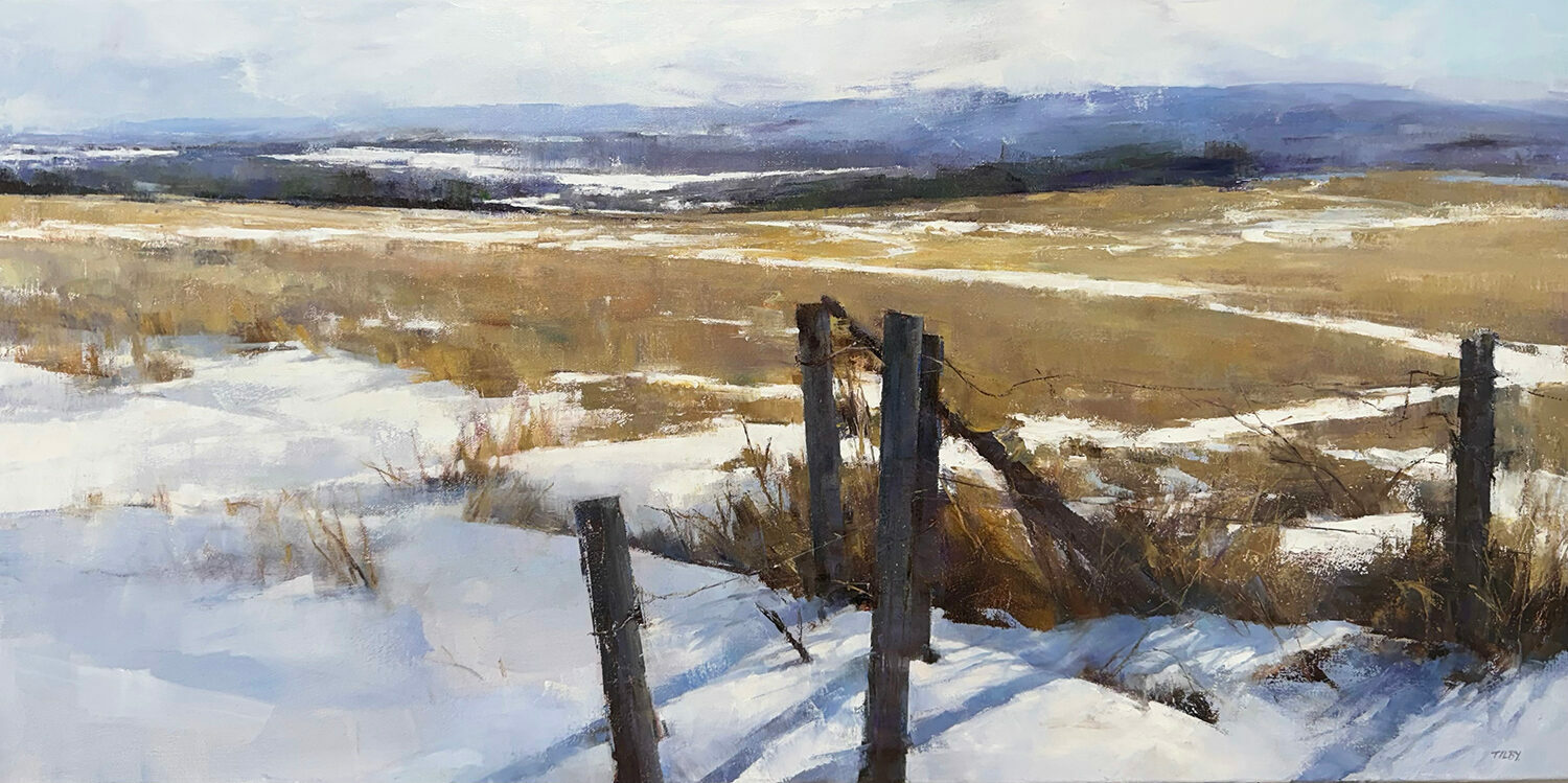 A snowy landscape with patches of dry grass and a wooden fence in the foreground, rolling hills in the background, and a pale sky above. 15th Annual PleinAir Salon Art Competition