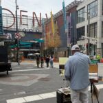 One of the artists painting on location at Denver Pavilions