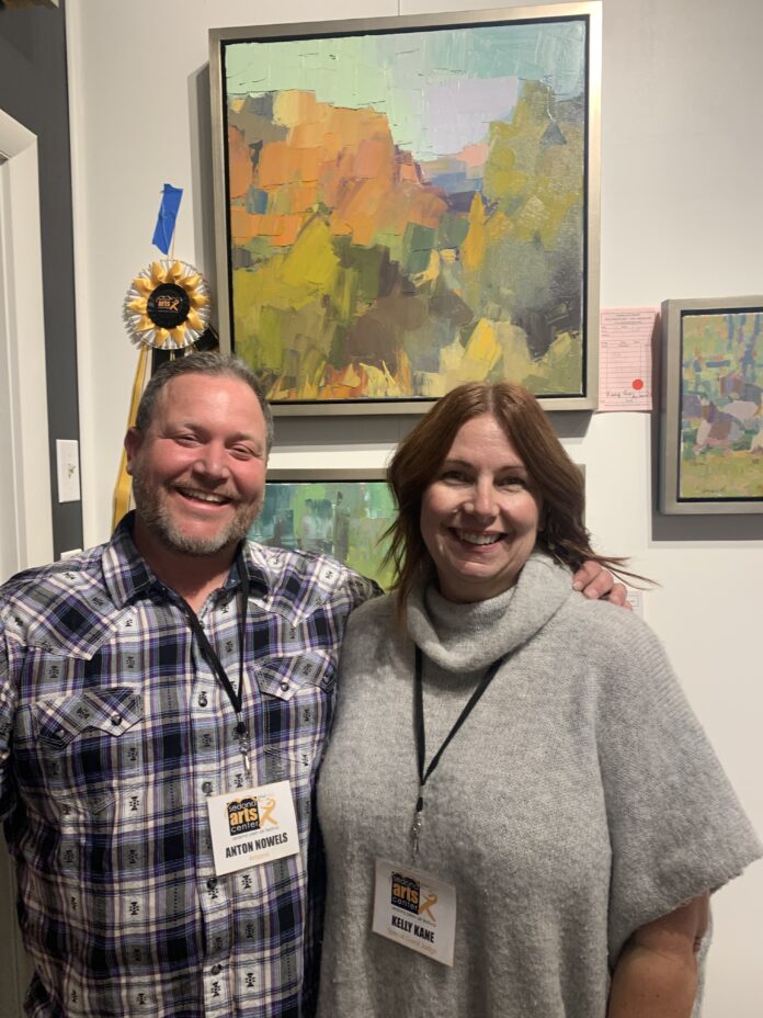 Best in Show winner Anton Nowels poses with PleinAir editor Kelly Kane in front of his award-winning painting.