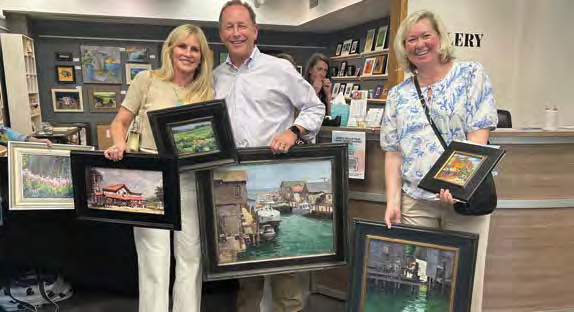 Happy collectors go home from Paint Grand Traverse with their hands full - plein air painting events