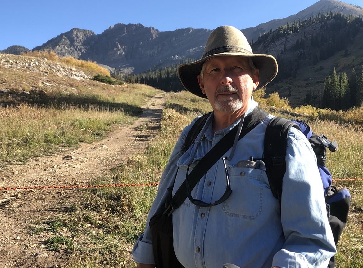 John Hughes Hiking to a Painting Location