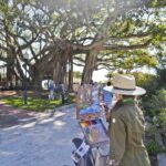 The Top Plein Air Painting Events for March 2026 Artist Kari Ganoung Ruiz plein air painting during the Lighthouse Paint Out Competition at Jupiter Inlet Lighthouse Museum