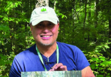 Plein air watercolor artist Richie Vios holding a painting